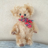 Flo, 18cm small Robin Rive bear, red nose, tartan scarf